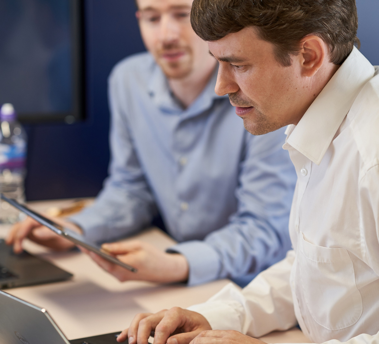 Helastel CTO showing colleague something on his screen