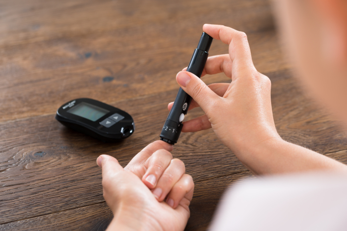 Diabetic person testing their blood sugar