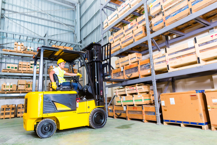 Warehouse employee driving a forklift truck